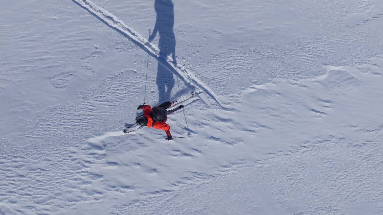 A professional skier hikes up a steep ridge in Verbier, then drops into an epic freeride descent. Pure adventure skiing in deep snow, dramatic terrain, and breathtaking alpine scenery.