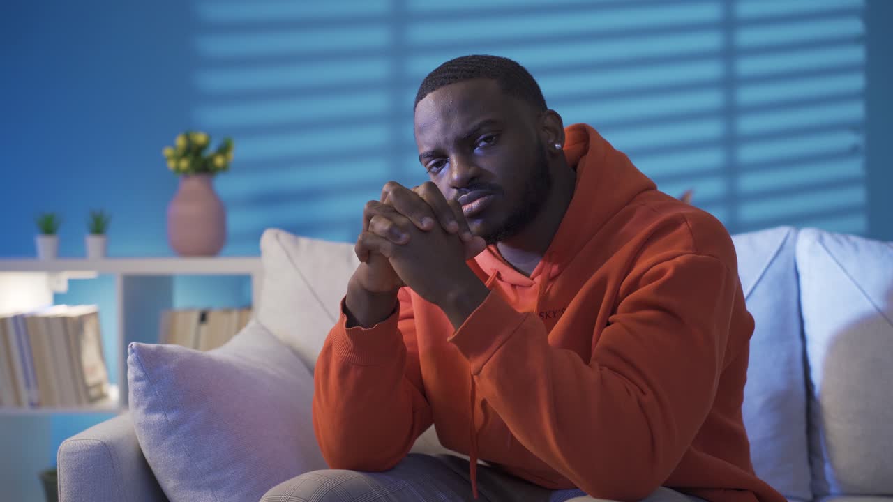 Thoughtful black man at home. Black man portrait.