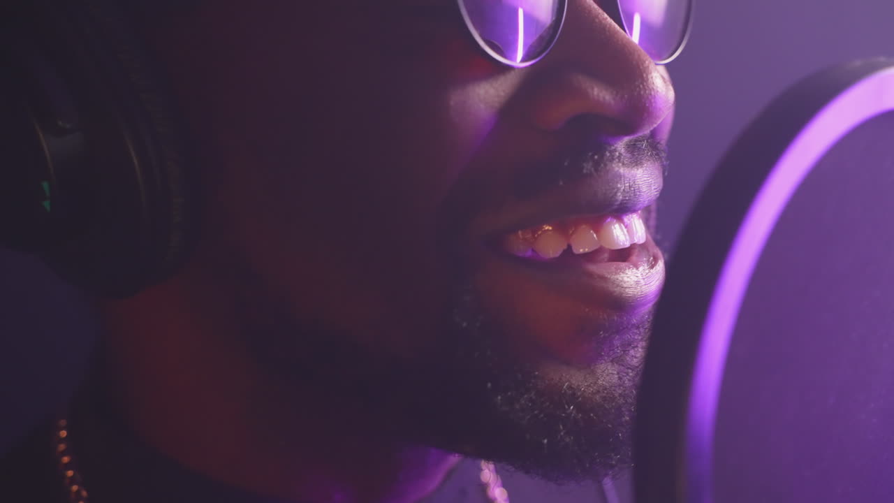 Closeup of a singer performing in a recording studio.