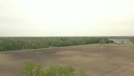 Farmer-in-tractor-cultivating-crop-in-field-take-11