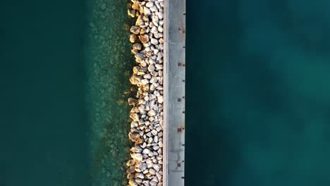 Top-view-of-marina-with-rocks-and-turquoise-waters