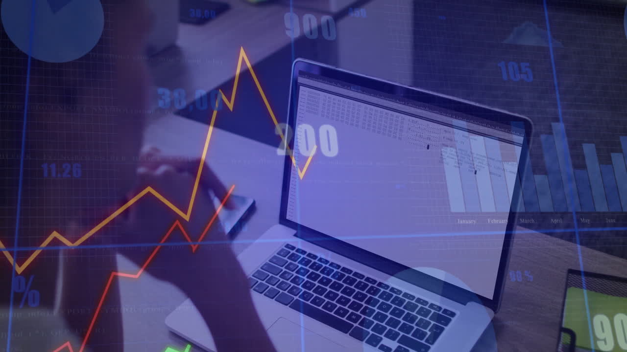 Financial data and graphs animation over person working on laptop at desk