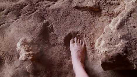 Step-of-primordial-barefoot-in-the-sandy-texture