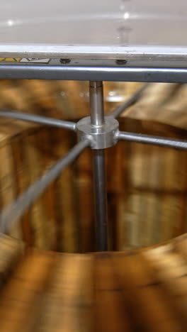 electric machine for honey removal rotating frames. close up. honey extractor working with opened lid. top view. vertical video