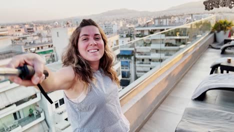 woman vlogging athens cityscape view from rooftop at sunset