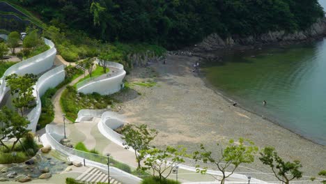 tourists swim at the rocky beach from geoje hanwha resort belvedere in south korea