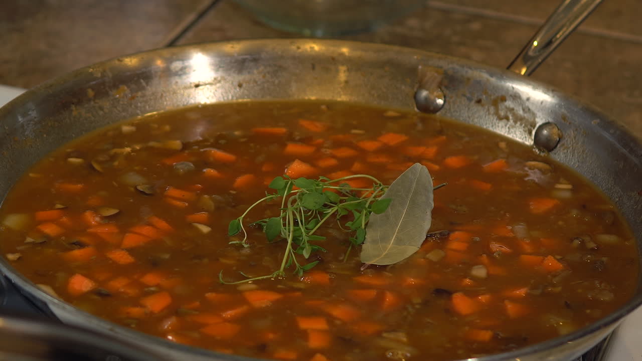 Garnishing delicious Vegan Shepherds Pie with bay leaves - Close up