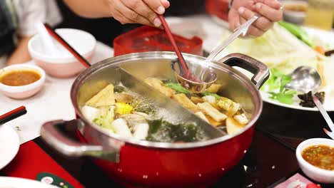 preparing and enjoying hotpot meal in bangkok