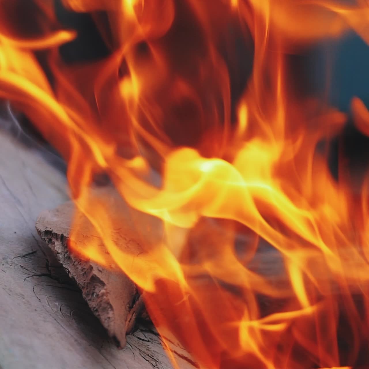 Close up of fireplace full of wood and fire. Slow motion