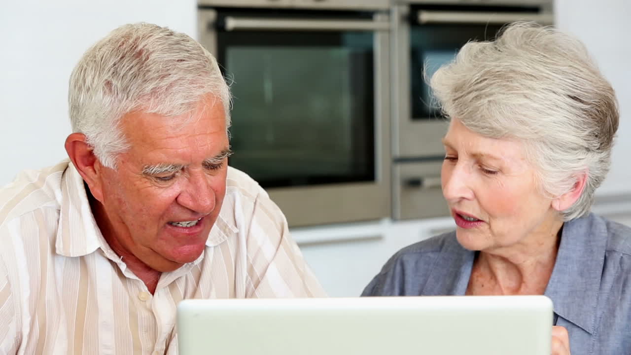 Senior couple using laptop together