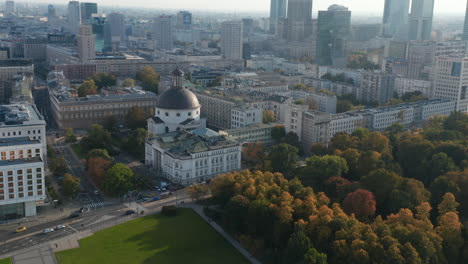High-angle-view-of-Pilsudski-Square-corner-with-surviving-part-of-Saxon-Palace.-Revealing-church-with-dome-and-downtown-high-rise-buildings.-Warsaw,-Poland