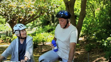 senior couple on bikes taking a break