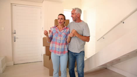 man surprising his wife with a new house