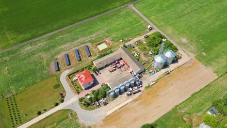 aerial view of farm, red barns, corn field in september