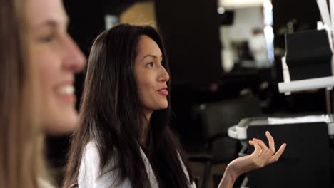 women at the hair salon interacting with each other