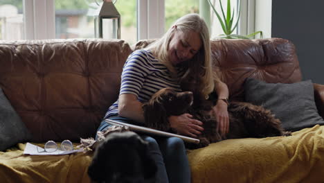 woman cuddling her dog on the couch