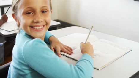 Portrait-of-girl-studying-in-classroom