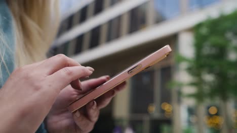 unrecognizable woman browsing phone in the city