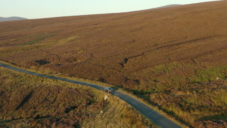 Aerial-view,-follow-shot,-4K,-drone-footage-following-a-car-driving-on-a-mountain-road