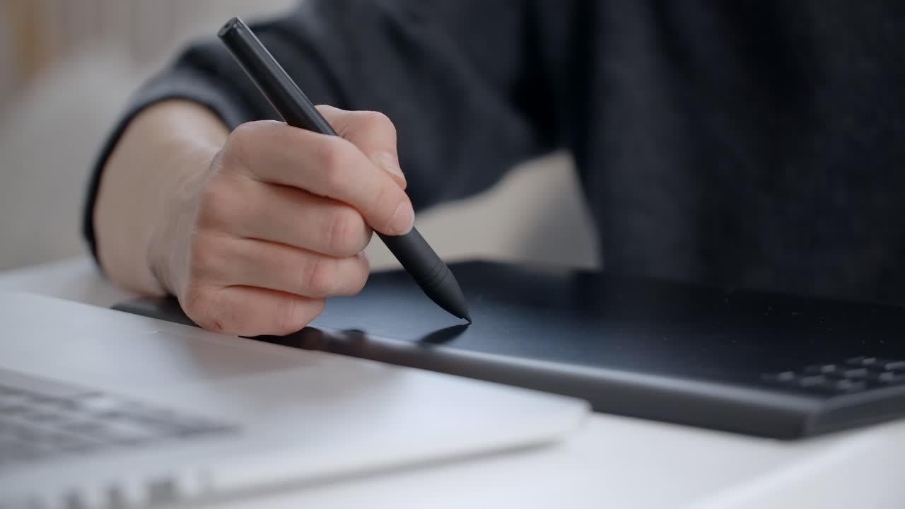 Person Using Graphics Tablet and Laptop for Digital Art