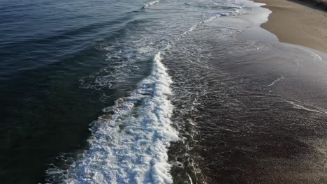 Excellent-Aerial-Shot-Of-Ocean-Waves-Receding-From-The-Shoreline-Of-Papohaku,-Hawaii