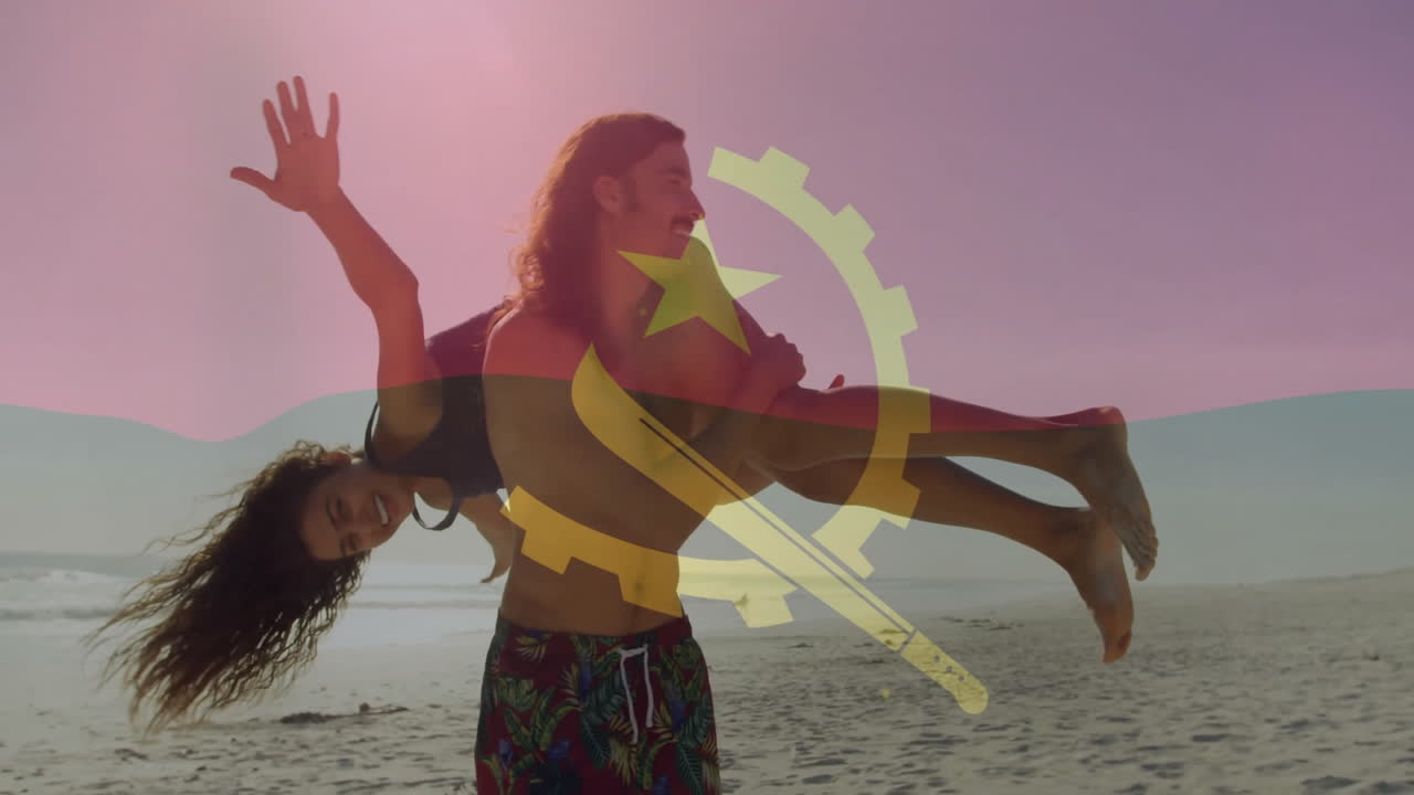 Carrying woman playfully on beach, man with animation of Angola flag overlay
