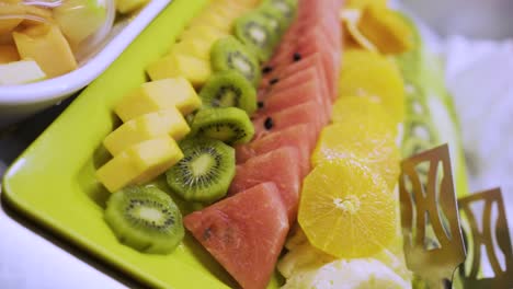 healthy fruits breakfast food buffet ,plates and table at a hotel