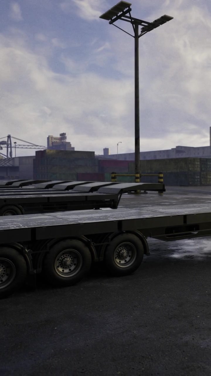Heavy transport vehicles parked at a loading area in a busy industrial location