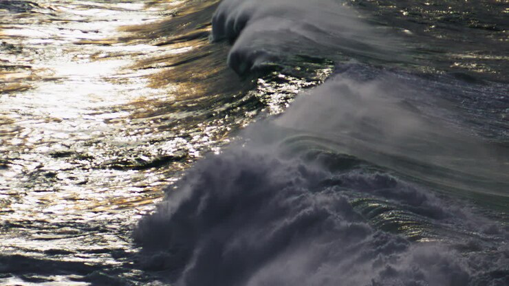 Waves rolling shiny surface in super slow motion. Powerful sea surf barreling