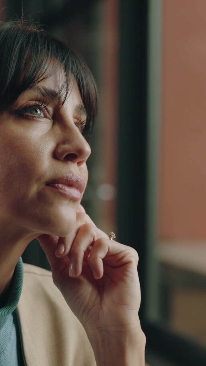 Thoughtful Woman Resting Chin on Hand While Looking Away
