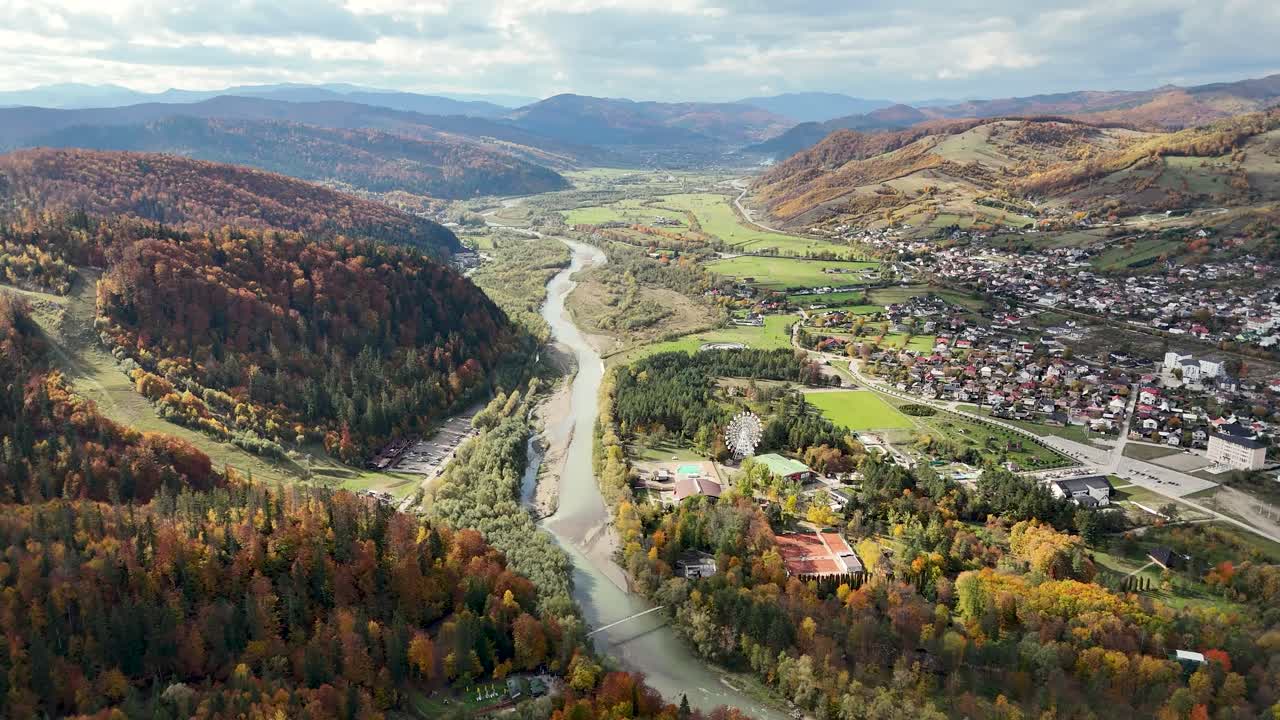 Drone footage showing Ariniș Park and Moldova River valley in Gura Humorului, surrounded by autumn hills