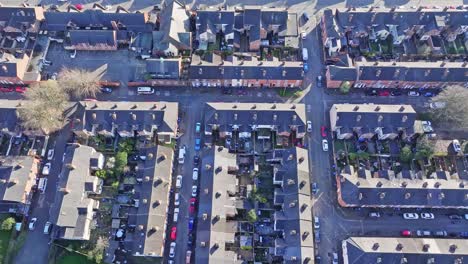 a cinematic shot from above over the rooftops of residential houses in derby, uk