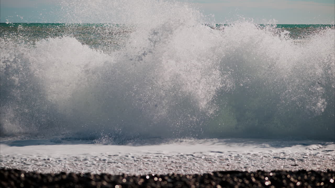 Waves hitting the shore on the beach in Cannes, France