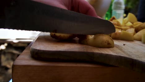 woman slicing baby potatoes outdoors