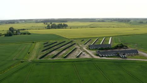 wide orbiting shoot over solar farm in crop fields