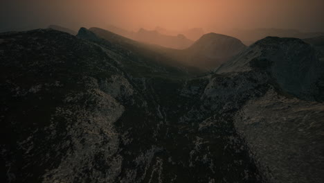 dramatic sky over rocky mountains at sunset