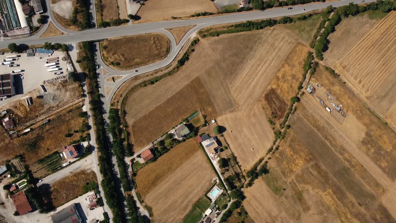 Aerial view of agricultural fields and a residential area