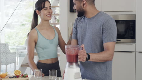 happy couple making healthy smoothie