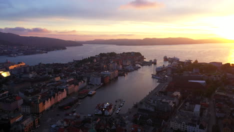 beautiful bright and colorful sunset over bergen, norway, seeing the famous fish market and bryggen from above