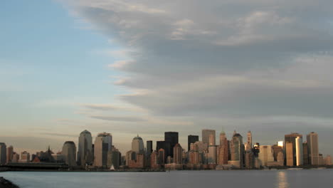 a large cloud bank gathers above the new york city skyline