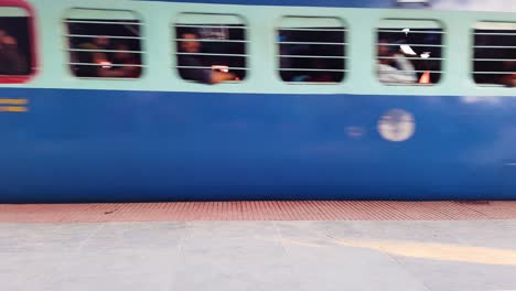 indian passenger express train crossing station on track at evening from flat angle video is taken at kamakhya railway station assam india on may 22 2022