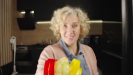 woman preparing vegetables and tomatoes in water