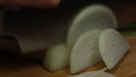 slow motion shot of chopping onion, process of preparing vegetables to cook meals