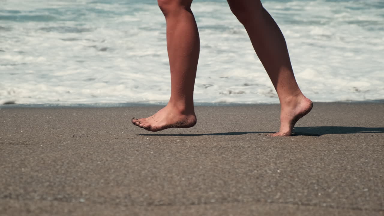Woman running barefoot on the beach