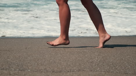 woman running barefoot on the beach