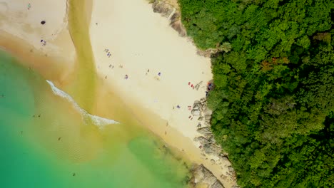 aerial high angle view of people enjoy swimming and relax on the beach in phuket thailand patong beach is a very famous tourist destination in phuket 4k aerial view drone top down beautiful beach