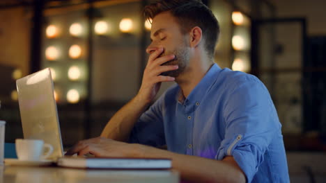 overworked businessman putting head on hands