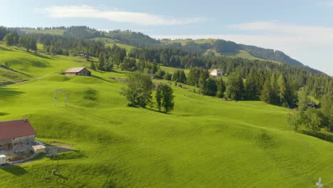 aerial view of rural homes perched on top of mountain in switzerland