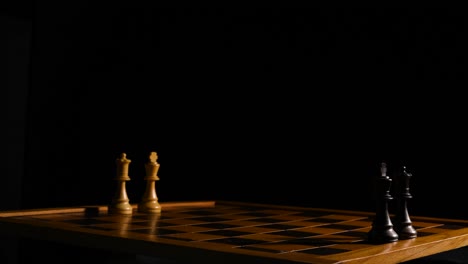 cinematic shot of a chessboard with only two kings and queen s on opposite sides of each other