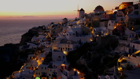 Windmills-line-the-hillsides-of-the-romantic-Greek-Island-of-Santorini-at-dusk